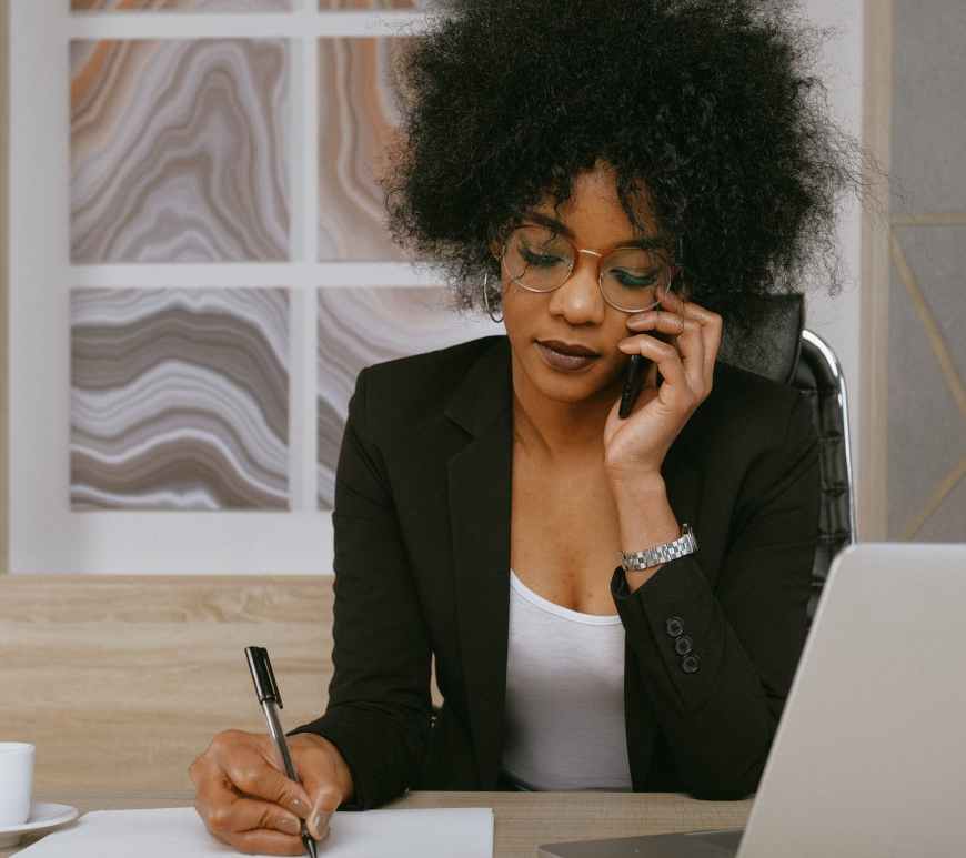 woman in black blazer holding smartphone